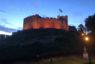 Tamworth Castle with external lights displaying yellow.